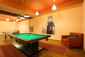 a living room with a pool table and a couch at Gorące Źródła Studio Centrum in Zakopane
