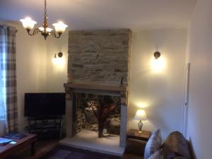 a living room with a fireplace and a television at The Dales in Stanhope