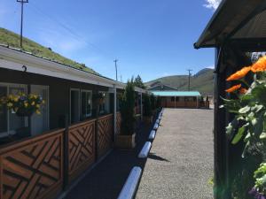 a building with a row of potted plants on it at Sunset Motel in Cache Creek