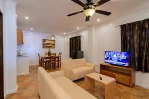 a living room with a couch and a flat screen tv at Bohol Sea Resort in Panglao