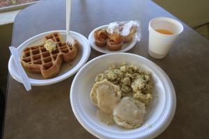 a table with three plates of breakfast foods and a drink at Shamrock Country Inn in Shamrock