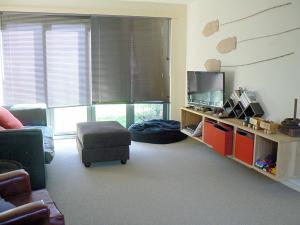 a living room with a couch and a tv at Seaside Idaho in Point Lonsdale