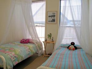 a bedroom with two beds and a window at Seaside Idaho in Point Lonsdale