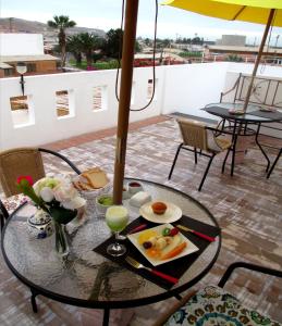 a table with a tray of food on a balcony at Guest Home Valto & Ziron in Arica