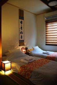 Postelja oz. postelje v sobi nastanitve Guesthouse Chayama