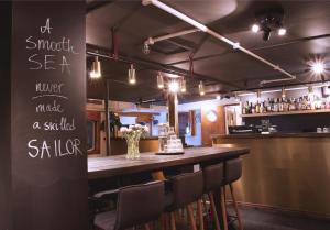 a bar with a table and chairs in a restaurant at Rygerfjord Hotel & Hostel in Stockholm