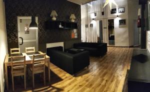 a living room with a couch and a table at Hostel Orange Plus in Toruń