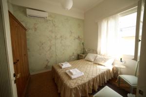 a bedroom with a bed with two towels on it at Sun sto Spiti in Athens +49 photos