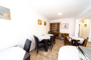 a restaurant with tables and chairs in a room at Villa Gradski Vrt in Osijek