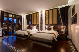 Giường trong phòng chung tại Khmer Paradise Villa