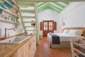 a kitchen with a bed and a sink in a room at Asymi Residences in Symi