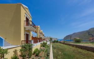 a row of houses with balconies on a street at Asymi Residences in Symi