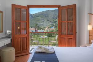 a bedroom with a bed and a view of a mountain at Asymi Residences in Symi