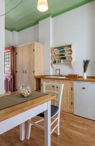 a kitchen with a wooden table and chairs at Asymi Residences in Symi
