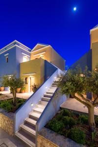 a house with a staircase leading up to it at night at Asymi Residences in Symi
