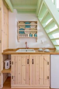 a kitchen with a sink and a vaulted ceiling at Asymi Residences in Symi