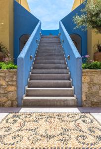 a staircase leading up to a blue building at Asymi Residences in Symi