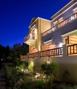a villa with a view at night at Asymi Residences in Symi