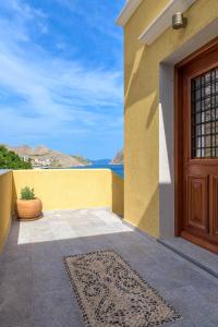 a door to a house with a view of the ocean at Asymi Residences in Symi