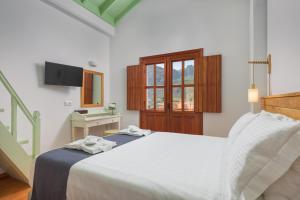 a bedroom with a bed with two towels on it at Asymi Residences in Symi