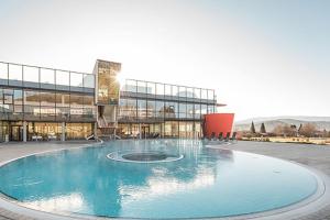 a large building with a fountain in front of it at Cafe Vielharmonie Apart-Pension in Maria Lankowitz