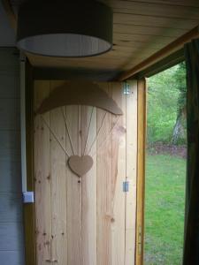 a door with a heart on the side of a house at Les chalets d'Alzen in Alzen