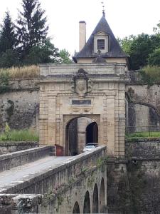 a stone building with a bridge with a gate at Entre Estuaire et Citadelle in Blaye