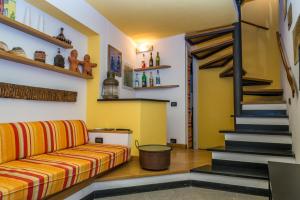 a living room with a couch and a staircase at Casa Di Mezzo by Arbaspàa in Manarola