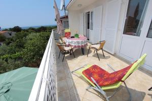 a patio with a table and chairs on a balcony at Apartments Monpeloso in Rovinj