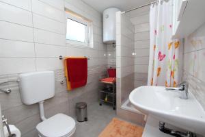 a white bathroom with a toilet and a sink at Apartments Monpeloso in Rovinj +37 photos