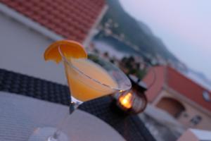 a drink sitting on a table with an orange slice at Blue Diamond Rooms in Zaton