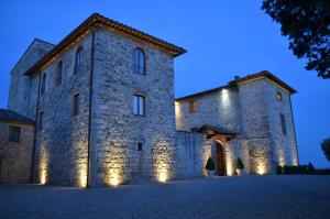 a building with a clock on the front of it at Castello La Leccia in Castellina in Chianti