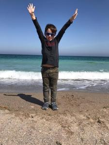 a man standing on the beach with his hands in the air at City Park Studio in Constanţa