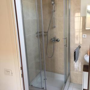 a shower in a bathroom with a glass shower stall at Apartment Patrizia in Zadar