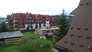 un grupo de edificios con techos rojos en una ciudad en Agroturystyka Pod Lasem, en Poronin