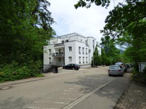 a white building on the side of a street at SeWeR Apartment in Baden-Baden
