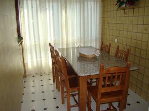 a dining room table and chairs with a table and a bowl on it at Apartamento Pedras in Vilagarcia de Arousa