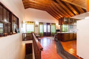 a large living room with a wooden ceiling at Adega do Pereirinha in São Roque do Pico