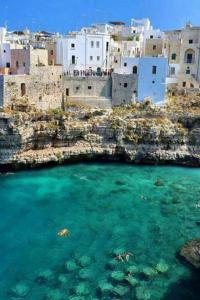 a group of buildings and the water in a harbor at Il sogno di Ele in Polignano a Mare