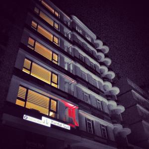 a tall building with lots of windows at night at Tk Kurdal Suit in Samsun