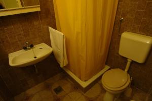 a bathroom with a toilet and a sink and a shower at Apartments Benito in Pješčana Uvala  +22 photos