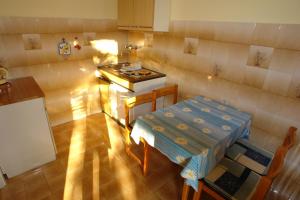 an overhead view of a kitchen with a table and a stove at Apartments Benito in Pješčana Uvala 