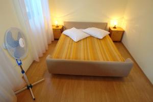 a bedroom with a bed and a tennis racket at Apartments Benito in Pješčana Uvala 