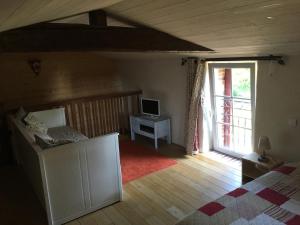 a bedroom with a bed and a desk with a computer at Gite "Le Puy Rabasteau" in Chantonnay