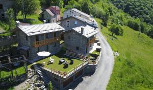 an aerial view of a large house on a hill at Chalets Mongioie in San Giacomo