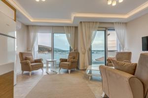 a living room with a view of the ocean at Paris Residence Cesme in Cesme