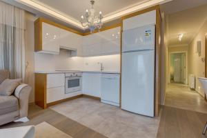 a kitchen with a large white refrigerator in a room at Paris Residence Cesme in Çeşme