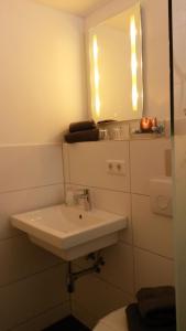 a bathroom with a white sink and a mirror at Ferienwohnung Felix Braunlage in Braunlage