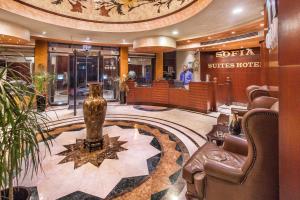 a lobby of a hotel with a vase on the floor at Sofia Suites Hotel in Amman