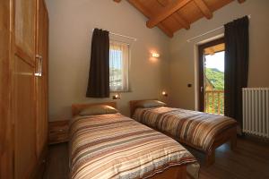 Posteľ alebo postele v izbe v ubytovaní CHALETS MONGIOIE Pra di Roburent